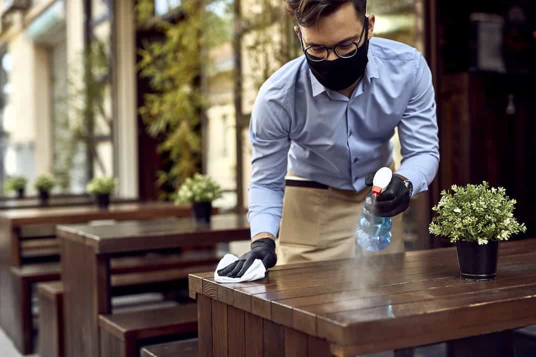 disinfecting a wooden table
