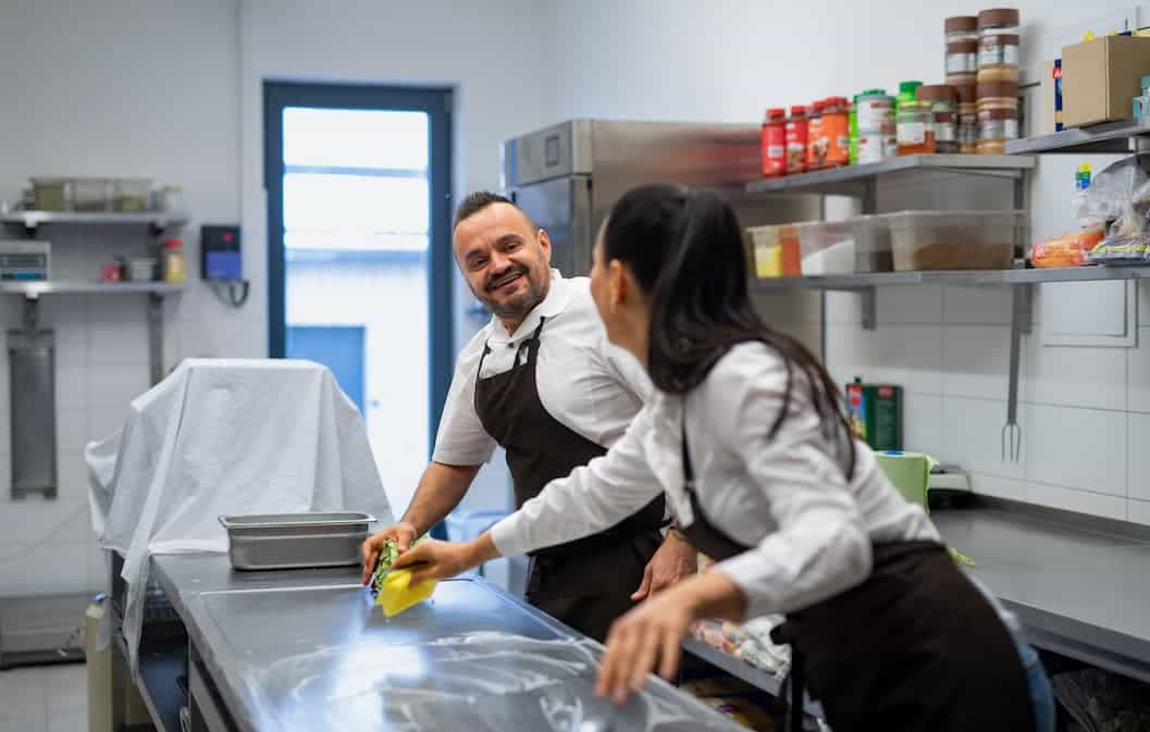 food handlers sanitizing food counter