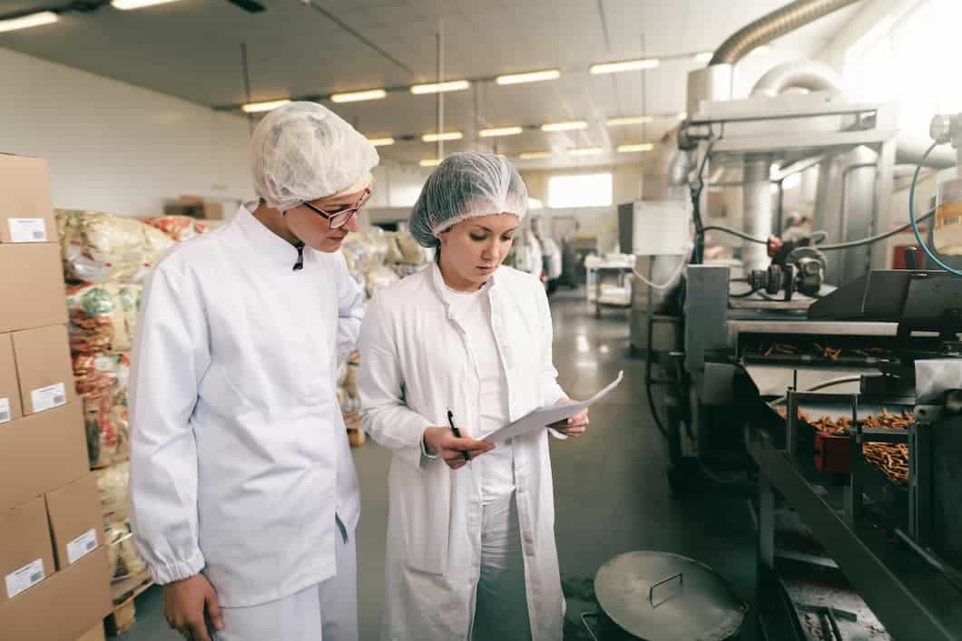 two specialists in the kitchen checking haccp system