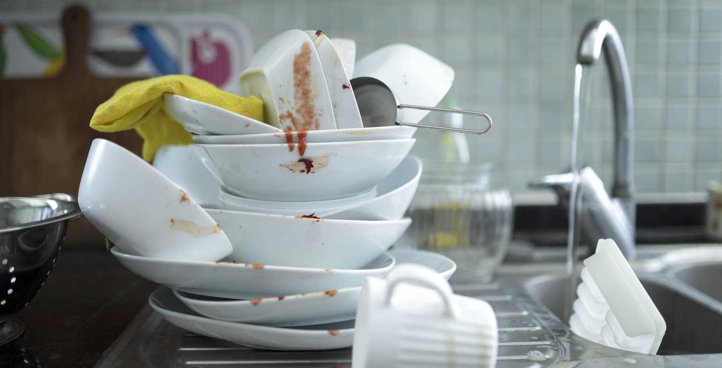 washing dishes in a three compartment sink